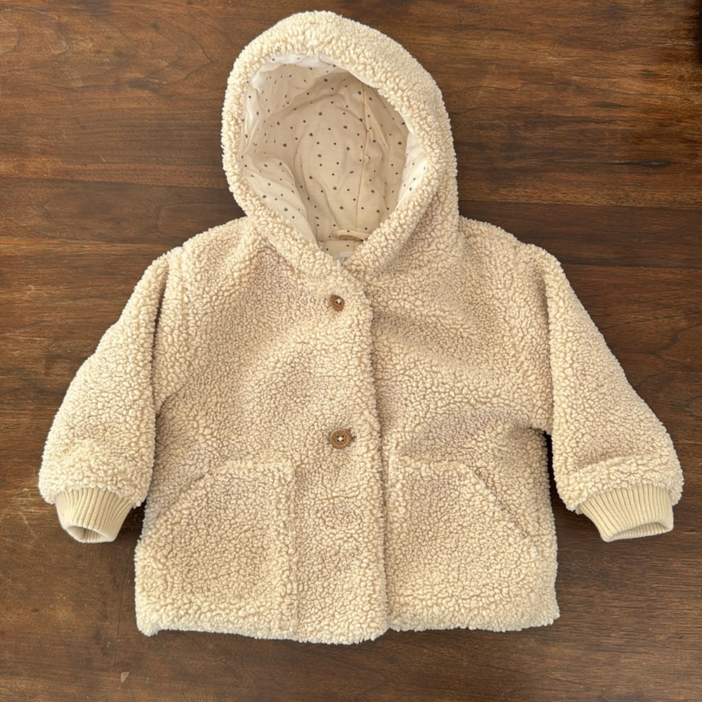 Fuzzy hooded toddler jacket.